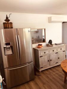 a kitchen with a stainless steel refrigerator and a counter at T2 de 50m2 indépendant à 15mn de Toulouse in Préserville +10 photos