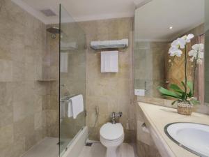 a bathroom with a toilet and a sink and a shower at Blu-Zea Resort by Double-Six in Seminyak