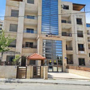 a building with an open door in front of it at 2 bedrooms apartment no 13 in Amman