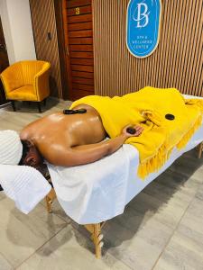 a naked man laying on top of a bed at GEORGE B BOUTIQUE LODGE in Tzaneen