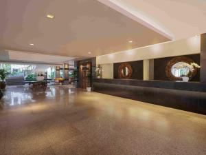 a large lobby with a reception desk in a building at Blu-Zea Resort by Double-Six in Seminyak