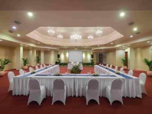 a large banquet hall with white tables and chairs at Blu-Zea Resort by Double-Six in Seminyak