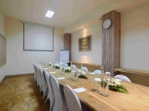 a conference room with a long table and white chairs at Blu-Zea Resort by Double-Six in Seminyak