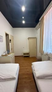 a room with two beds and a blue ceiling at Wald Hotel Lagodekhi in Lagodekhi