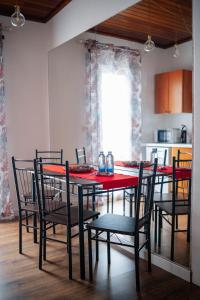 a dining room with a red table and chairs at CASA RURAL GA7COLORES only adult in Montaña Blanca