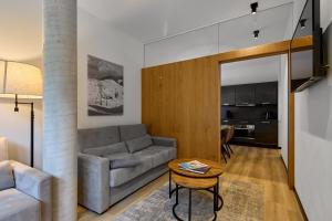 a living room with a couch and a table at Belvedere - Alpin-Resort Montafon Haus 3 by Pferd auf Wolke in Gargellen