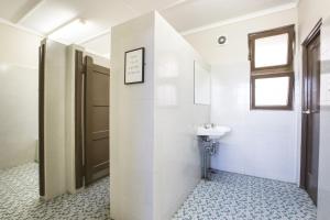 a bathroom with a sink and a toilet at Toongabbie Hotel in Blacktown