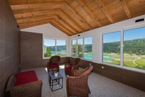 a room with chairs and a table and windows at Villa GRACO in Imotski