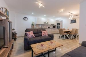 a living room with a couch and a table at Villa GRACO in Imotski