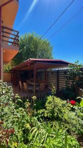 a house with a patio with chairs and plants at Casa Cristal in Eforie Nord