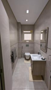 a bathroom with a sink and a toilet at New Cairo Serviced Apartment in Cairo