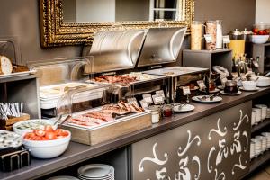 a buffet line with food on display in a restaurant at Hotel Sigulda in Sigulda