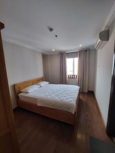 a bedroom with a bed in a room with a window at Felix Alley in Ho Chi Minh City +16 photos
