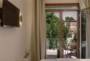 a bedroom with a sliding glass door to a patio at Avli in Preveza