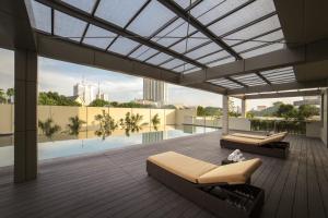 a living room with a view of a pool on a building at Sumatra36 Apartment in Surabaya