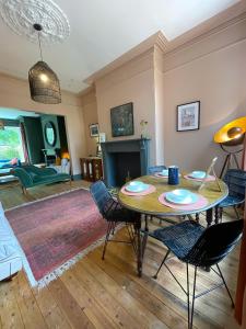 a living room with a table and chairs at Spacious home in Leeds ideal for gatherings with free parking in Leeds
