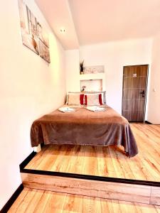 a bedroom with a bed and a wooden floor at Nice 1Room Condo WarszawaCenter in Warsaw