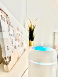 a white cup sitting on a table in a room with pictures at Nice 1Room Condo WarszawaCenter in Warsaw +43 photos