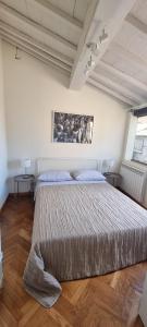 a bedroom with a large bed and two tables at Alba -vista unica con terrazza- in Siena