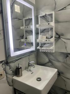 un baño con lavabo y espejo en Villa Fatos - beach apartment, en Vlorë