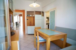a kitchen with a wooden table and a dining room at Casa Ameris by Affitti Brevi Rimini in Rimini