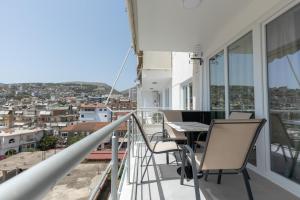a balcony with a table and chairs on it at The View - Tiffany Luxury 2 BR, Free Parking, Central in Sarandë