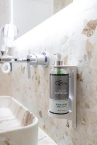 a bottle of soap in a bathroom next to a sink at The View - Tiffany Luxury 2 BR, Free Parking, Central in Sarandë +40 photos