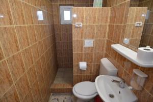 a bathroom with a toilet and a sink at Holiday House Costinesti in Costinesti +78 photos