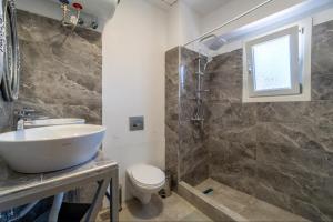 a bathroom with a sink and a toilet and a shower at Villa Angelique in Sinarádes +66 photos