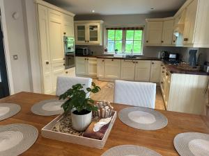 a kitchen with a wooden table with a potted plant at 7 Oakwood Manor Kenmare in Kenmare