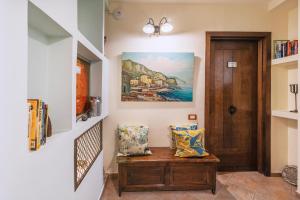 a hallway with a bench and a painting on the wall at Hotel Il Convento in Naples