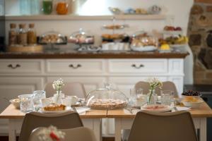 a table with food on it in a kitchen at Domo Incantos in Galtellì