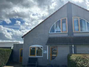 a house with windows on the side of it at Kustverhuur, Vakantiepark Fort Soleil 60 in Breskens