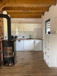 a kitchen with a fireplace in the middle of a room at Modern House in Korne