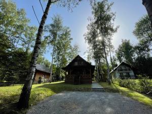 a pavilion at the end of a road next to a house at Soliński Zając in Werlas