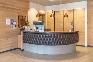 a bar in a restaurant with wooden walls at Hotel Ariston in Levico Terme +38 photos