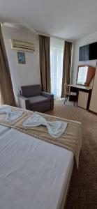 a hotel room with a bed and a couch at Elite Family Hotel in Kiten