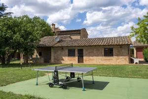 a ping pong table in front of a house at Assisi Villa Simi in Petrignano