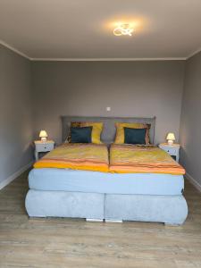 a large bed in a room with two night stands at Ferienwohnung Sonnenschein in Ostseebad Sellin