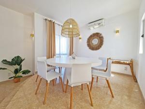 a white dining room with a white table and chairs at Casa Vitória - with private pool in Pêra