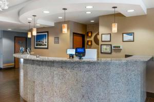 a large lobby with a large counter in a hospital at Comfort Suites Redding - Shasta Lake in Redding