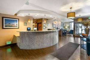 a lobby with a bar in the middle of a room at Comfort Suites Redding - Shasta Lake in Redding