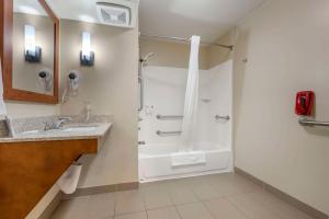 a bathroom with a shower and a sink at Comfort Suites Redding - Shasta Lake in Redding