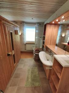 a large bathroom with a sink and a toilet at Ferienwohnung Mona, 65314 in Moormerland