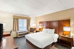 a hotel room with a large bed and a desk at Comfort Inn White River Junction in White River Junction +39 photos