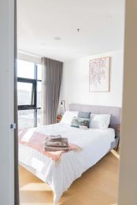 a bedroom with a bed with towels on it at 2 Bedroom 2 bath 1 Car on Lonsdale Street in Canberra
