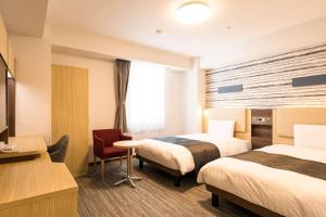 Postel nebo postele na pokoji v ubytování Comfort Hotel Nagoya Fushimi