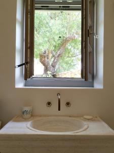 a bathroom with a sink under a window at Oxalis Villas in Perlengiánika +71 photos