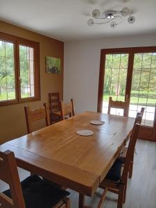 a dining room with a wooden table and chairs at Gite d'ALTONA in Coyolles