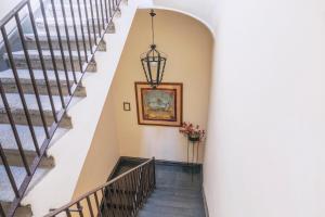 a staircase in a house with a painting on the wall at Hotel Il Convento in Naples
